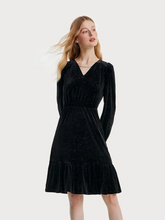 a lady in black v-neck velvet dress